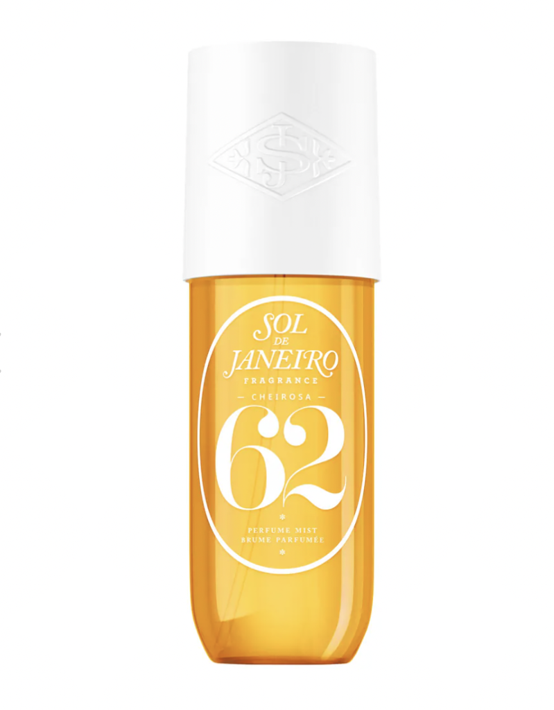 A bottle of Sol de Janeiro's Brazilian Crush Cheirosa '62 fragrance mist, featuring a golden yellow liquid in a clear bottle with a white cap. The label showcases the brand and product name prominently.